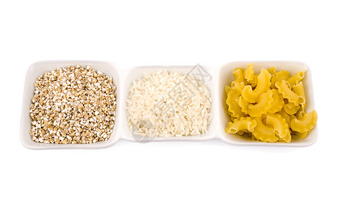 Groats 大米和意大利面盘子白色碎粒小吃食物厨房黄色烹饪背景图片