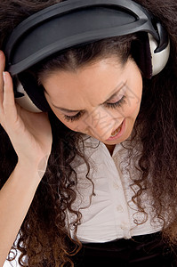 妇女享受音乐歌曲成人乐趣配饰女性工作室冒充调谐耳机技术图片