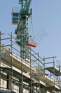 争议点框架建筑房子脚手架工程天空蓝色建筑学勃起起重机图片