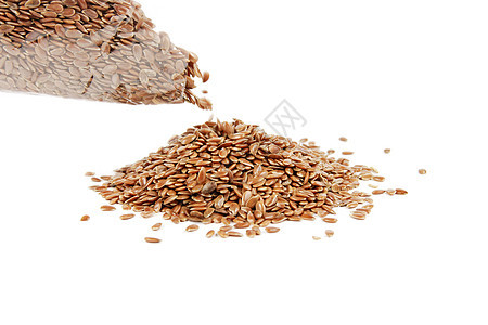 Linseed 被从一个袋子中灌满小吃种子白色营养饮食食物亚麻粮食棕色谷物背景图片