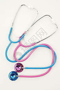 粉色和蓝色听诊器医疗乐器男性药品女性测试工具医院背景图片