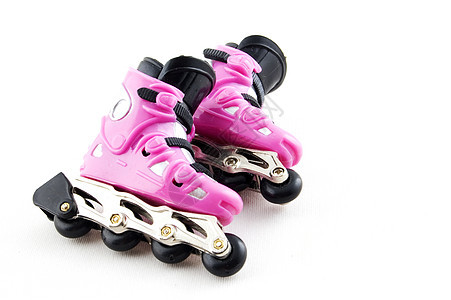白色背景上的粉红滚式隔开车轮滑冰衣服旱冰滚筒闲暇享受活动活力休闲图片