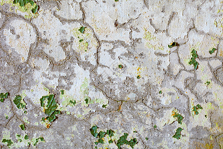 旧石膏上绿色涂料的裂缝和斑点图片