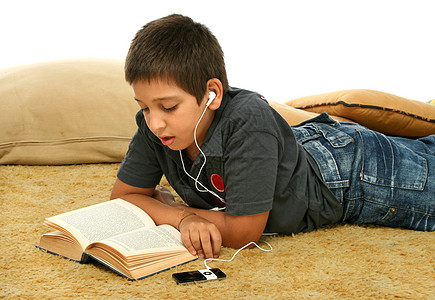 男孩阅读和听听音乐教科书耳塞学生知识音乐播放器孩子们视频测试图片