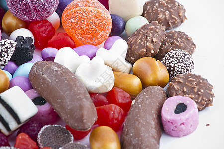 白背景上有很多糖果 鲜花零食焦糖紫色幸福催肥水晶橡皮糖派对甜点便利糖衣图片