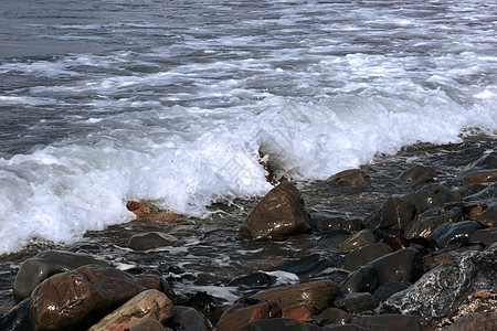 岸边的石子天空热带海洋蓝色海岸大理石旅行阳光海带波浪图片
