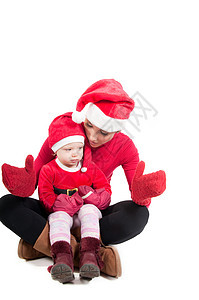 圣诞老人母亲和女儿在工作室白色女孩宝贝金发女性帽子婴儿孩子女士红色图片
