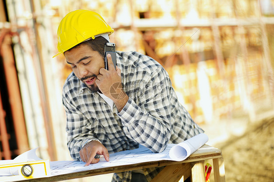 建筑业工人体力劳动者帽子安全帽头盔工地蓝图年轻人成人项目电话图片