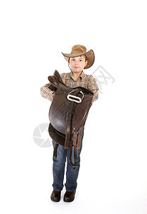 带着马鞍的男孩牛仔全身牛仔裤帽子雇农乡村皮革衬衫马术男性图片