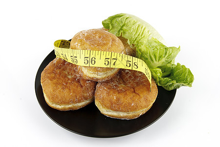 Doughnuts和带磁带测量器的Lettacece蛋糕饮食沙拉面团甜点沙漠食物面包糕点午餐图片