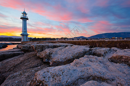 日内瓦市风景灯塔码头建筑指导港口警告石岩蓝色太阳红色日出图片