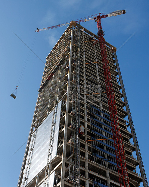 在摩天大楼建筑工地抬起起起重机图片