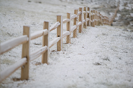 冬季的分割铁路围栏邮政滑轨场地栏杆平行线杂草新雪栅栏图片