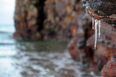 悬崖面上结冰的冰柱钟乳石支撑波浪天气冻结环境蓝色岩石滴水冻土图片