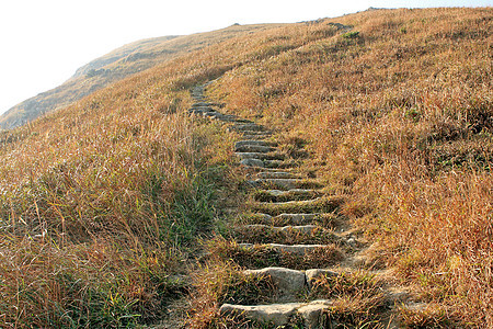 穿过山岳的路径旅行石头地标风景远足旅游岩石太阳爬坡砂岩图片