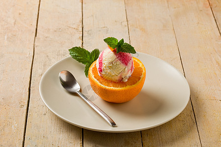 橙色冰淇淋桌子乳制品奶油状牛奶叶子水果创意茶匙橙子甜点图片