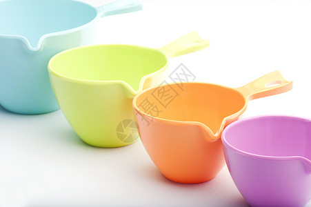 测量杯食物用具塑料橙子粉色蓝色杯子厨房烹饪绿色图片
