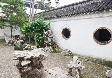 中国苏州有名的齐济林花园森林植物编队吸引力住宅花园狮子岩石建筑物房子图片
