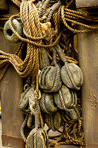 旧绳和木制板滑轮实木码头绳索图片