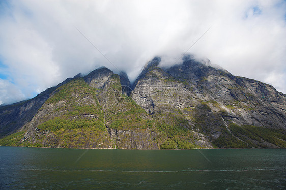 Geiranger 视图反射石头海洋蓝色海岸峡湾地区悬崖山坡爬坡图片