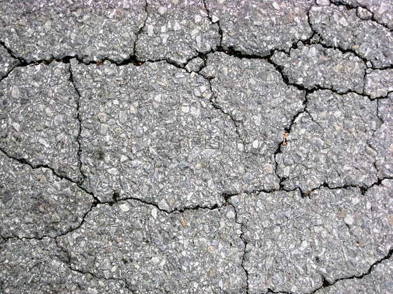 沥青背景的裂缝损害地面黑色路面墙纸石头宏观街道人行道灰色图片