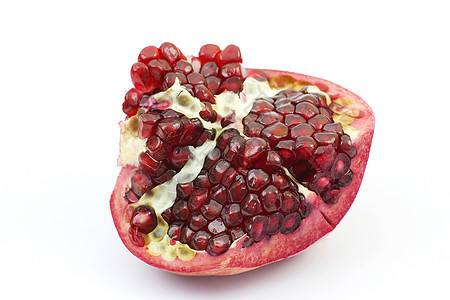 多汁的石榴食物异国盘子白色红色假种皮营养叶子水果热带图片