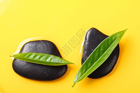 SPA或zen六氯环乙烷岩石冥想环境黄色黑色石头叶子绿色生态花园图片