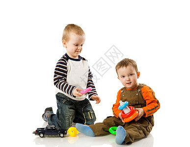 男孩玩游戏喜悦兄弟姐妹金发好奇心儿童童年塑料车辆地面幸福图片