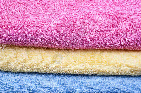 彩色毛巾温泉蓝色卫生棉布纺织品洗衣店浴室淋浴黄色粉色背景图片