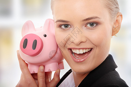 拥有小猪银行的女商务人士女性银行业人士储蓄喜悦投资退休经济女士银行图片