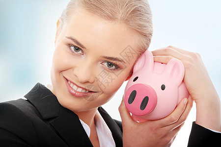 拥有小猪银行的女商务人士女士快乐安全金发退休商业银行业账单喜悦投资图片