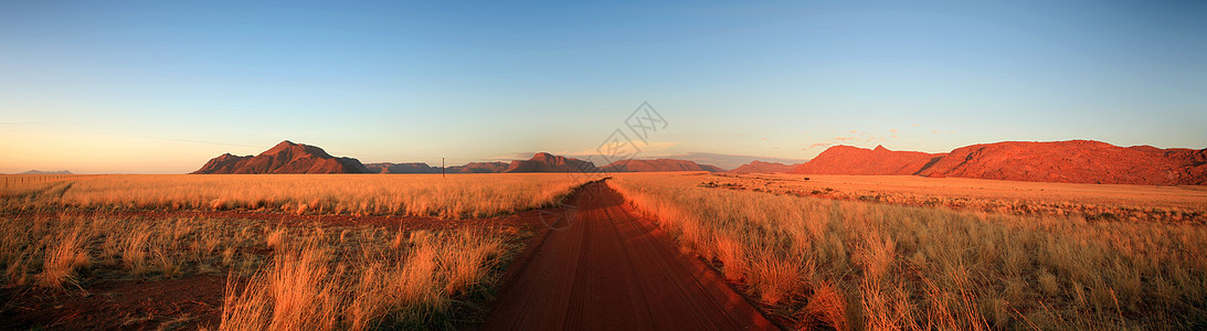 桑迪路通往农场衬套速度风景土地植物草原地平线小路岩石云景图片