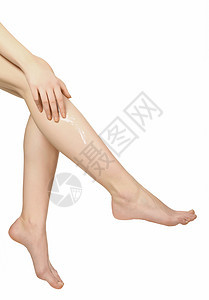 两条有润湿剂体奶油的女双腿手指保健橘皮剥皮卫生美甲女性皮肤润肤治疗图片