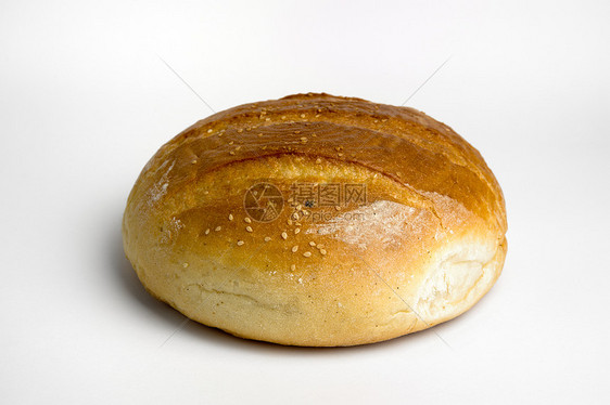 面包饼圆形面包小麦棕色食物芝麻摄影美食白色工作室图片