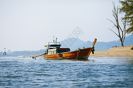 长尾船天空照片岩石海景假期蓝色海滩海岸运输水晶图片