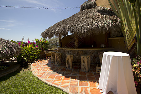 墨西哥热带度假胜地的酒吧色彩小屋茅草天空建筑泳池波纹阴影蓝色游泳池图片