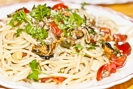 带贝贝壳的意大利面条盘子刀具食物叶子海鲜草本植物贝类菜单美食凹痕图片