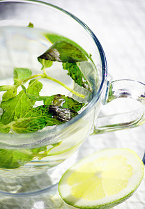 一杯加柠檬和薄荷茶玻璃白色健康饮食饮料水果食物草本植物盘子杯子叶子图片