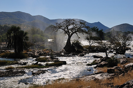 Epupa瀑布日出 纳米比亚日落悬崖洪水薄雾巨石急流戏剧性强光彩虹岩石图片