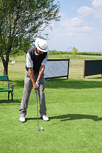 高尔夫球场的资深高尔夫球运动员背景图片