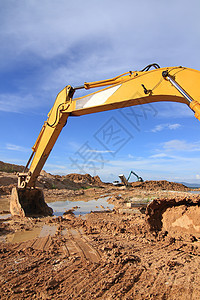 CO2在室外工作时进行挖土作业的挖掘机装载机搬运工矿业运动土壤蓝色推土机车辆建造挖掘拖拉机图片