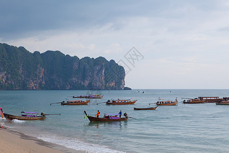 海上渔船蓝色尾巴晴天假期悬崖天堂情调热带异国海滩图片