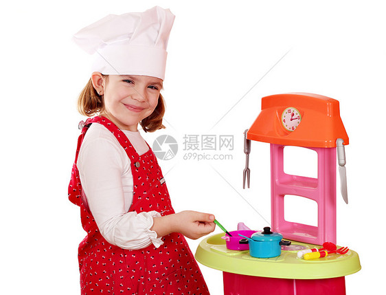 美丽的小女孩在做烹饪图片