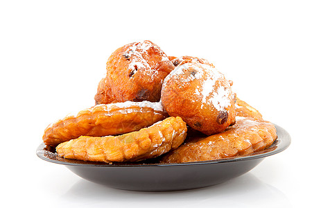 与荷兰甜甜甜圈和苹果更替派对食物国家失误葡萄干育肥橄榄球粉状盘子传统图片