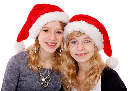 两个戴着圣诞帽子的女孩金发女郎微笑孩子们季节性工作室背景图片