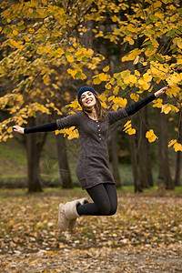 跳跃享受树叶森林行动公园叶子女孩乐趣成人女性图片