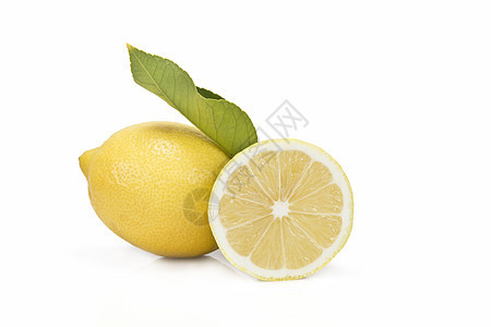 切一个柠檬半白色饮食黄色绿色蔬菜果汁水果营养静物树叶图片