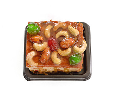 水果蛋糕 夹坚果和干果盘子食物葡萄干营养传统蛋糕甜点水果腰果烘烤图片