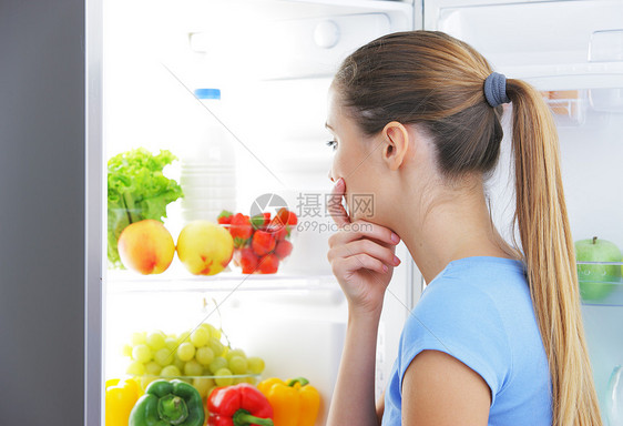 选择食物的年轻妇女思考饮食牛奶冰箱蔬菜女孩微笑香肠女子水果图片