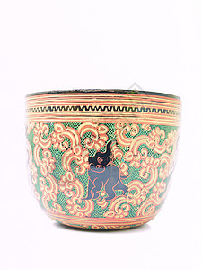 一个艺术的花瓷碗 上面有被随意孤立的象像绿色黑色手工风格白色装饰品漆器手工业黄色装饰图片